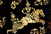 Wat Xieng Thong temple in Luang Prabang, Laos. Detail of the  intricate gold stencilling on black lacquer that decorate the walls of the sim. 